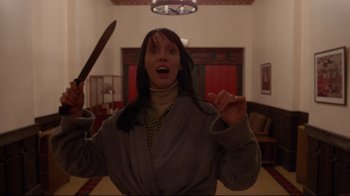Movie still from “The Shining” (1980), directed by Stanley Kubrick – A woman holding a knife in her hands; Medium shot, Low angle