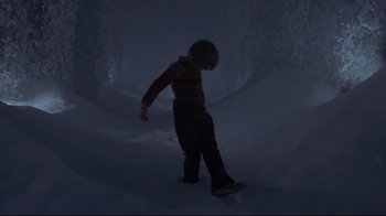 Movie still from “The Shining” (1980), directed by Stanley Kubrick – A young child is standing in the snow; Wide shot, Low angle