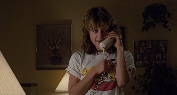 Movie still from “The Terminator” (1984), directed by James Cameron – A woman holding a phone up to her ear; Close Up shot, Low angle