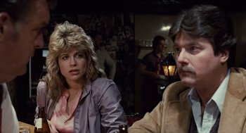 Movie still from “The Terminator” (1984), directed by James Cameron – A woman sitting next to a man at a table; Close Up shot, Over the shoulder angle