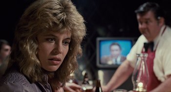 Movie still from “The Terminator” (1984), directed by James Cameron – A woman sitting in front of a television; Close Up shot, Over the shoulder angle