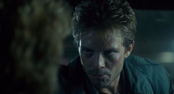 Movie still from “The Terminator” (1984), directed by James Cameron – A person wearing a black shirt; Close Up shot, Over the shoulder angle
