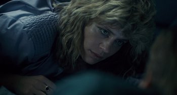 Movie still from “The Terminator” (1984), directed by James Cameron – A person laying on the ground; Close Up shot, Overhead angle