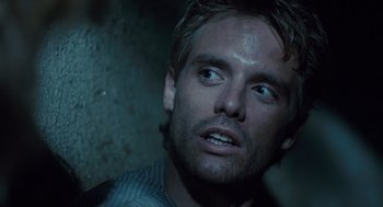 Movie still from “The Terminator” (1984), directed by James Cameron – A person looking up at the sky; Close Up shot, Over the shoulder angle