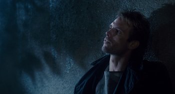 Movie still from “The Terminator” (1984), directed by James Cameron – A man looking up into the sky while wearing a jacket; Close Up shot, Low angle