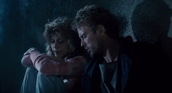 Movie still from “The Terminator” (1984), directed by James Cameron – A man and a woman sitting next to each other; Medium shot, Low angle