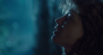 Movie still from “The Terminator” (1984), directed by James Cameron – A person looking up at the sky; Close Up shot, Over the shoulder angle