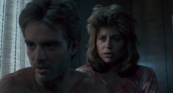 Movie still from “The Terminator” (1984), directed by James Cameron – A man and a woman are looking at the camera; Close Up shot, Over the shoulder angle