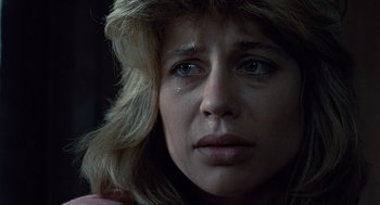 Movie still from “The Terminator” (1984), directed by James Cameron – A person with a crying face; Close Up shot, Low angle