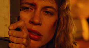 Movie still from “The Terminator” (1984), directed by James Cameron – A person with blood all over their face; Close Up shot, Low angle