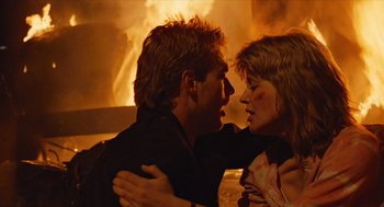 Movie still from “The Terminator” (1984), directed by James Cameron – A man and a woman in front of a fire; Close Up shot, Low angle