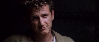 Movie still from “The Thin Red Line” (1998), directed by Terrence Malick – A person wearing a jacket; Close Up shot, Over the shoulder angle
