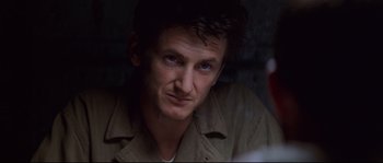 Movie still from “The Thin Red Line” (1998), directed by Terrence Malick – A person wearing a jacket; Close Up shot, Over the shoulder angle