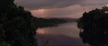 Movie still from “The Thin Red Line” (1998), directed by Terrence Malick – A body of water under a cloudy sky; Extreme Wide shot, High angle