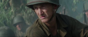 Movie still from “The Thin Red Line” (1998), directed by Terrence Malick – A person wearing a helmet; Close Up shot, Over the shoulder angle