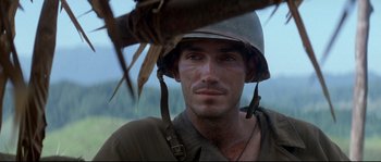 Movie still from “The Thin Red Line” (1998), directed by Terrence Malick – A man wearing a hat and a uniform; Close Up shot, Over the shoulder angle