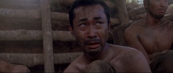 Movie still from “The Thin Red Line” (1998), directed by Terrence Malick – A person with a beard; Close Up shot, Low angle