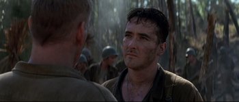 Movie still from “The Thin Red Line” (1998), directed by Terrence Malick – A man with a beard is talking to another man; Close Up shot, Over the shoulder angle