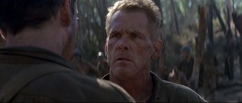 Movie still from “The Thin Red Line” (1998), directed by Terrence Malick – A person with a beard; Close Up shot, Over the shoulder angle