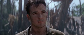 Movie still from “The Thin Red Line” (1998), directed by Terrence Malick – A person wearing a jacket; Close Up shot, Low angle