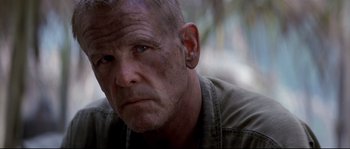 Movie still from “The Thin Red Line” (1998), directed by Terrence Malick – An older man with a beard and a nose ring; Close Up shot, Low angle