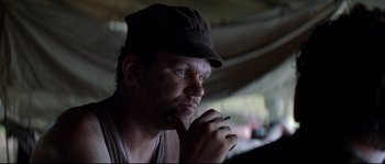 Movie still from “The Thin Red Line” (1998), directed by Terrence Malick – A person wearing a hat; Close Up shot, Over the shoulder angle