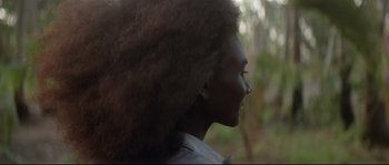 Movie still from “The Thin Red Line” (1998), directed by Terrence Malick – A person's face with trees in the background; Close Up shot, Over the shoulder angle