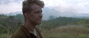 Movie still from “The Thin Red Line” (1998), directed by Terrence Malick – A person in a field; Close Up shot, Low angle