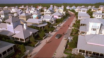 Movie still from “The Truman Show” (1998), directed by Peter Weir – An aerial view of a street with many houses on it; Extreme Wide shot, High angle