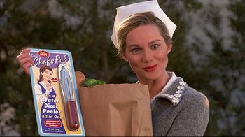 Movie still from “The Truman Show” (1998), directed by Peter Weir – A woman holding a paper bag with food in front of it; Close Up shot, High angle