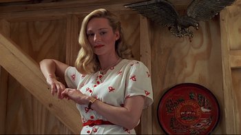 Movie still from “The Truman Show” (1998), directed by Peter Weir – A beautiful blonde woman in a white and red dress; Medium shot, Low angle