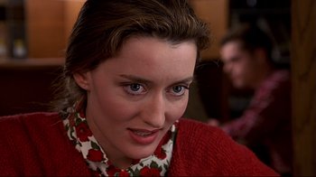 Movie still from “The Truman Show” (1998), directed by Peter Weir – A person wearing a red sweater; Close Up shot, Over the shoulder angle