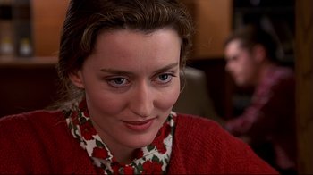 Movie still from “The Truman Show” (1998), directed by Peter Weir – A person wearing a red sweater; Close Up shot, Over the shoulder angle