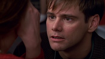 Movie still from “The Truman Show” (1998), directed by Peter Weir – A person with his eyes wide open; Close Up shot, Over the shoulder angle