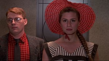 Movie still from “The Truman Show” (1998), directed by Peter Weir – A man and a woman with a red hat on their head; Close Up shot, Low angle