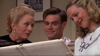 Movie still from “The Truman Show” (1998), directed by Peter Weir – A man and two women looking at a piece of paper; Close Up shot, Over the shoulder angle