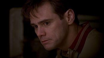Movie still from “The Truman Show” (1998), directed by Peter Weir – A person looking at the camera; Close Up shot, High angle
