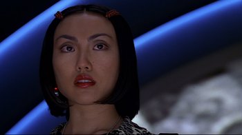 Movie still from “The Truman Show” (1998), directed by Peter Weir – A person with short black hair; Close Up shot, Low angle