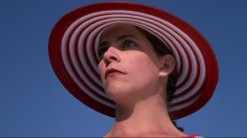 Movie still from “The Truman Show” (1998), directed by Peter Weir – A person wearing a red and white hat; Close Up shot, Low angle