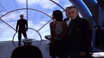 Movie still from “The Truman Show” (1998), directed by Peter Weir – A group of people standing in front of a sky background; Wide shot, Over the shoulder angle