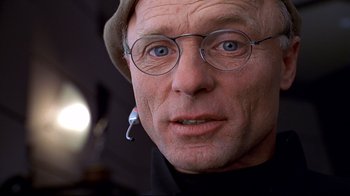 Movie still from “The Truman Show” (1998), directed by Peter Weir – An older man wearing glasses and wearing a hat; Extreme Close Up shot, Overhead angle