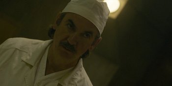 Movie still from “Chernobyl” (2019), directed by Johan Renck – A person wearing a hat; Close Up shot, Low angle