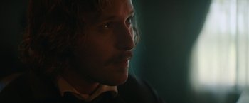 Movie still from “The Underground Railroad” (2021), directed by Barry Jenkins – A man's face in the dark; Close Up shot, Over the shoulder angle