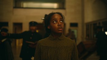 Movie still from “The Underground Railroad” (2021), directed by Barry Jenkins – A young girl looking up into the air; Close Up shot, Low angle