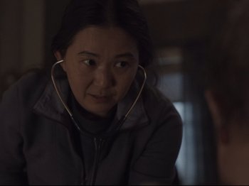 Movie still from “The Whale” (2022), directed by Darren Aronofsky – A woman with a stethoscope around her neck; Medium shot, Over the shoulder angle