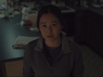 Movie still from “The Whale” (2022), directed by Darren Aronofsky – A woman is sitting in front of a table; Medium shot, Over the shoulder angle