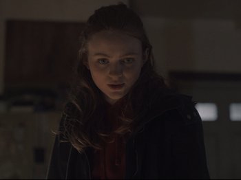 Movie still from “The Whale” (2022), directed by Darren Aronofsky – A young girl is standing in a dark room; Close Up shot, Over the shoulder angle