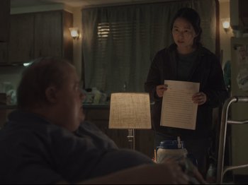 Movie still from “The Whale” (2022), directed by Darren Aronofsky – Two people in a room with papers in front of them; Medium shot, Over the shoulder angle
