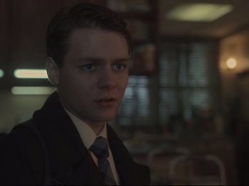 Movie still from “The Whale” (2022), directed by Darren Aronofsky – A man in a suit and tie in a room; Close Up shot, Over the shoulder angle