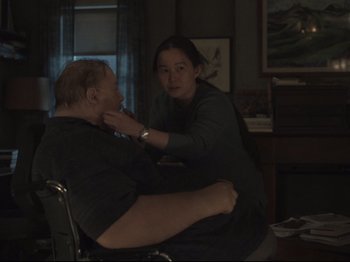 Movie still from “The Whale” (2022), directed by Darren Aronofsky – A man sitting in front of a woman in a chair; Medium shot, Over the shoulder angle
